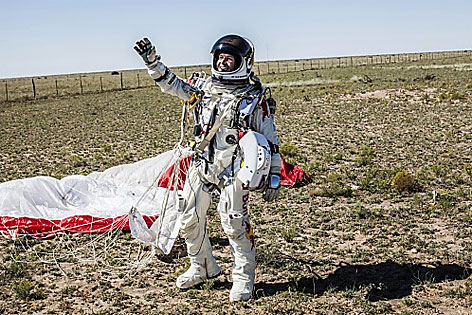 Baumgartner mit Raumanzug u Fallfschirm bei der Landung